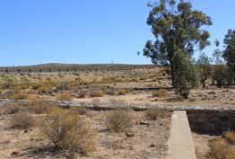 The Ruins of the Klipfontein Hotel - Historic Landmark at Anenous Pass, Northern Cape The ruins of the Klipfontein Hotel at Anenous Pass in the Northern Cape, South Africa, featuring stone walls and a water tower once used for Port Nolloth railway locomotives